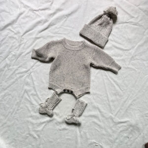 3-piece winter outfit solution featuring a knit romper, matching beanie, and booties