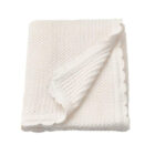 White cotton baby knit blanket with scallop edge flat lay