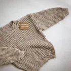 chunky knit oversized speckled baby sweater set back view flat lay product photo