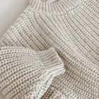 chunky knit speckle cotton baby sweater pullover side view or detail closeup photo