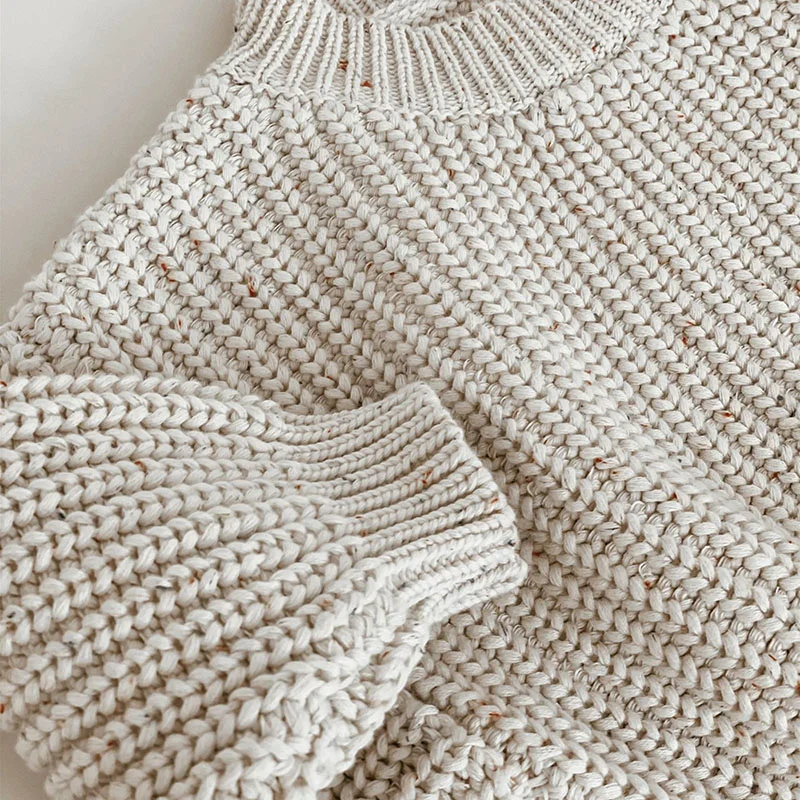 chunky knit speckle cotton baby sweater pullover side view or detail closeup photo