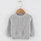 organic cotton baby jumper sweater side view or detail closeup photo