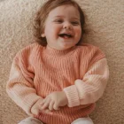 organic cotton chunky knitted baby sweater jumper texture and fabric detail photo