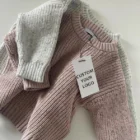 soft knitted baby sweater jumper winter side view or detail closeup photo