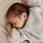 soft knitted baby sweater jumper winter lifestyle or baby wearing photo