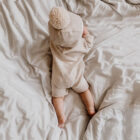 speckle knit baby romper sweater long sleeve back view flat lay product photo