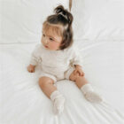 speckle knit baby romper sweater long sleeve texture and fabric detail photo