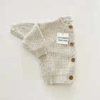 speckled chunky knit cardigan baby sweater side view or detail closeup photo
