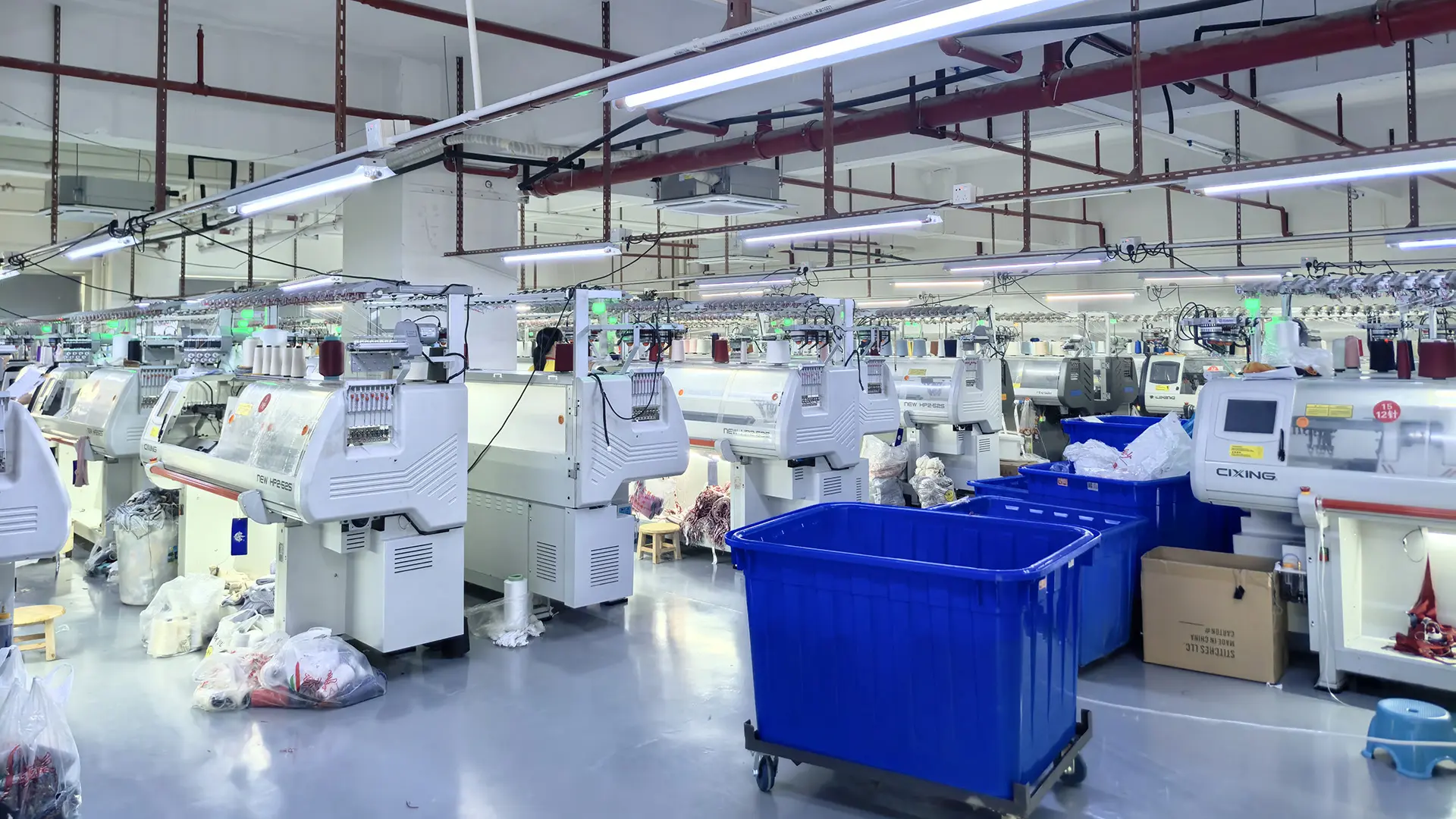Custom sweater manufacturer workshop with computerized knitting machines for OEM and ODM knitwear production
