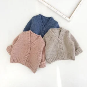plain knitted infant baby cardigan sweater front view flat lay product photo