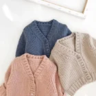 plain knitted infant baby cardigan sweater back view flat lay product photo
