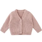 plain knitted infant baby cardigan sweater texture and fabric detail photo