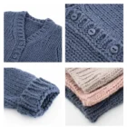 plain knitted infant baby cardigan sweater lifestyle or baby wearing photo
