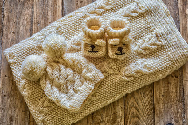 Baby clothes on a vintage wooden table.