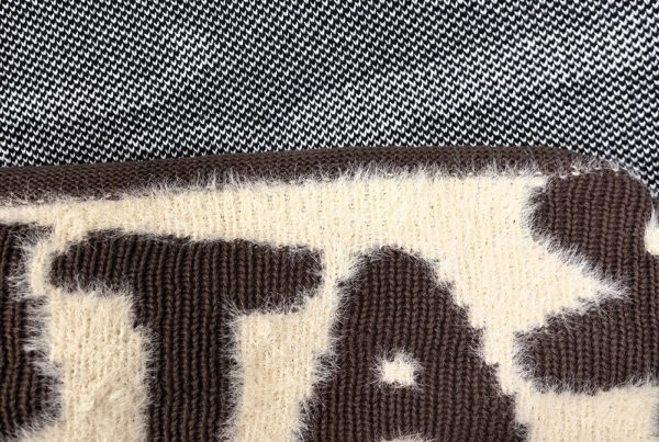 Close-up comparison of jacquard and intarsia knitwear showing different yarn and pattern structures