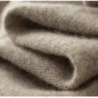 Macro of the oatmeal cashmere knit fabric showing fine vertical ribbing and visible fine fibers