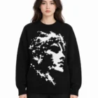 Female model wearing the black cotton jacquard knit sweater with the portrait pattern on the front