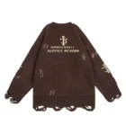Back view of the brown sweater with an emblem above two lines of reversed gothic lettering and a dagger motif on the sleeve