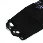 Close-up of the black ribbed hem with long loose yarn loops hanging from the edge