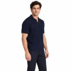 Male model wearing the navy ribbed knit polo, side view