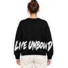 Female model wearing the black slogan jacquard sweater, back view