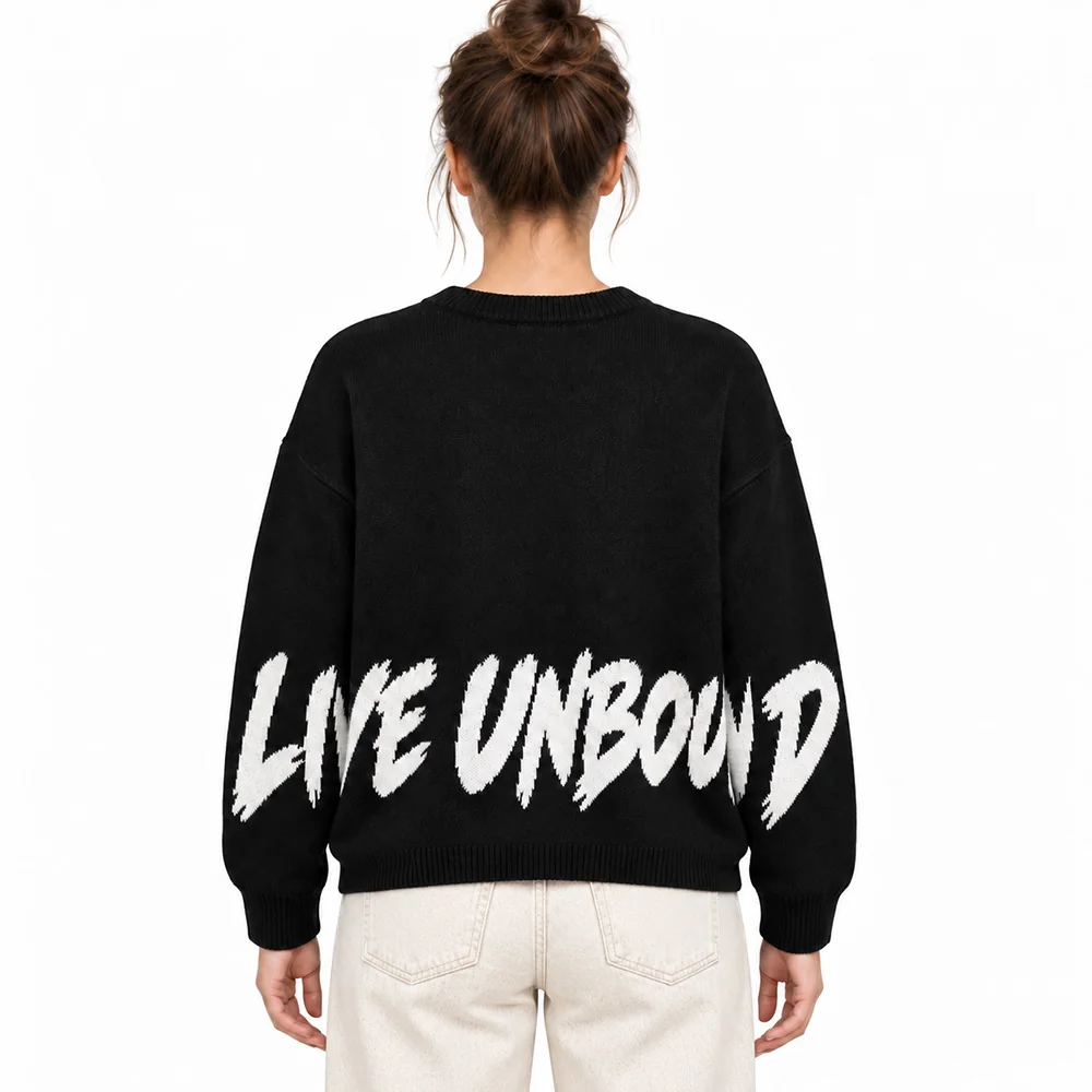 Female model wearing the black slogan jacquard sweater, back view