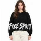 Female model wearing the black slogan jacquard crew neck sweater