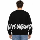 Male model wearing the black slogan jacquard sweater, back view with LIVE UNBOUND slogan