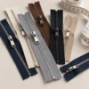 Assorted half-zip sweater zippers and measuring tape prepared for custom knitwear sampling and development